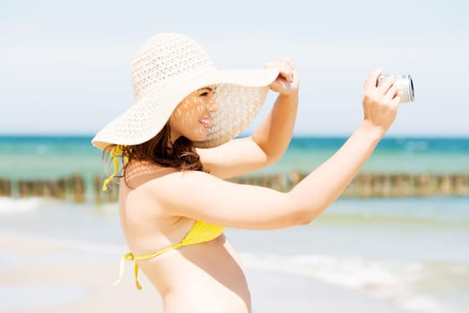 attractive cheerful young woman talking with digital camera.