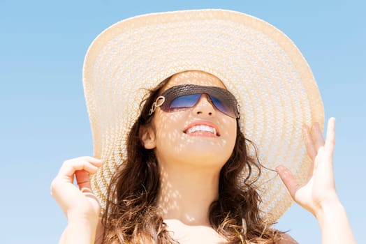 Beautiful woman on a beach. Coastline in sunglasses.