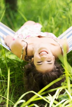 young woman lying in a hammock in the garden