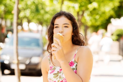 portrait of young happy woman eating ice-cream,outdoor