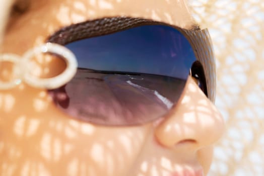 beautiful woman on a beach. coastline in sunglasses.