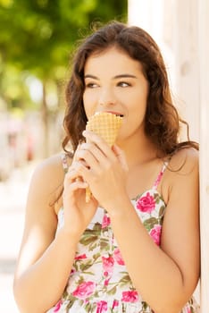 Portrait of young happy woman eating ice-cream,outdoor