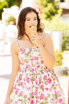 Portrait of young happy woman eating ice-cream,outdoor