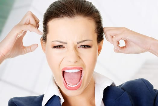 Stressed or angry businesswoman screaming loud