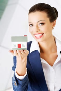 female businesswoman holding and protecting the house. home protecting concept for insurance or security or real estate