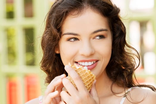 portrait of young happy woman eating ice-cream,outdoor