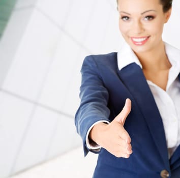 a beautiful businesswoman about to shake hands.