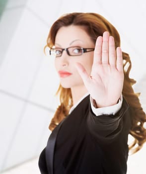 serious business woman gesturing stop sign