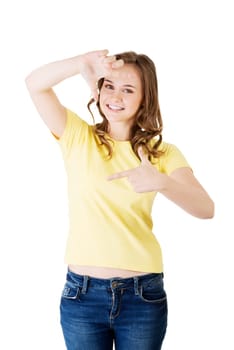 smiling woman wearing red blouse is showing frame by hands. happy girl with face in frame of palms. isolated on white background.