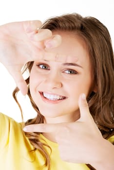 smiling woman wearing red blouse is showing frame by hands. happy girl with face in frame of palms. isolated on white background.