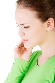 teen woman pressing her with a painful expression. she is having a terrible tooth ache.