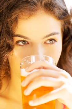 attractive young woman drinking beer on sidewalk cafe.