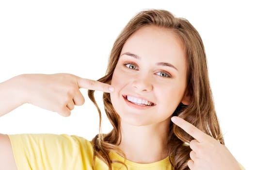 teen girl pointing on her perfect teeth,isolated on white