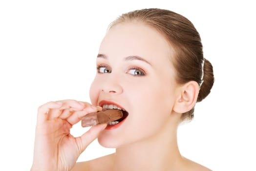 young beautiful woman eating a bar,isolated on white