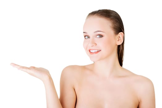 attractive woman with clean skin presenting copy space on her palm