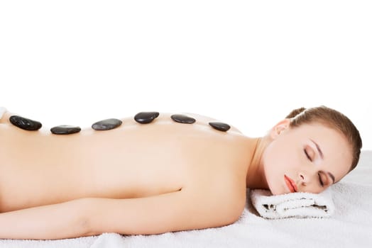 beauty woman relaxing in a spa. stone massage. isolated.