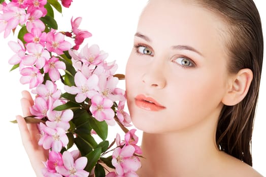 Beauty face of the young beautiful woman with flower. Girl on white background