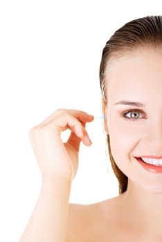 woman face closeup while cleaning up an ear with a swab,over white.