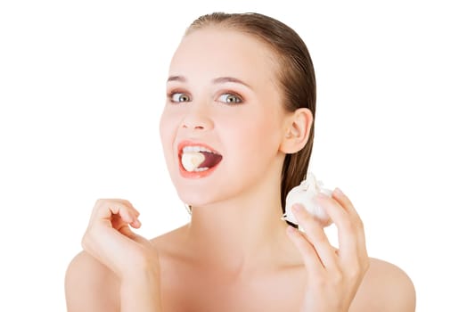 Young beautiful woman eating garlic. Healthy eating concept. Natural antibiotic that fight infection