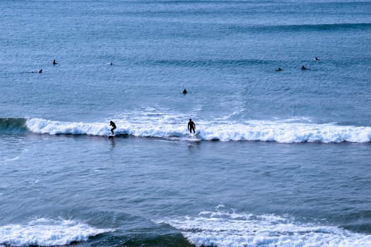 beautiful clean atlantic ocean with surfers catching the waves on Irelands coast