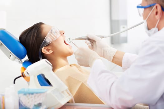 Photo of female open mouth during treatment with bur