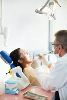 Photo of female open mouth during treatment with bur