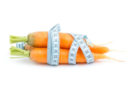 Carrot wrapped by measure tape on the white background