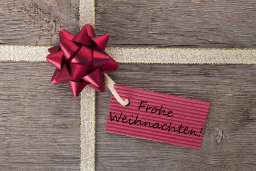the german words Frohe Weihnachten which means merry christmas on a red banner