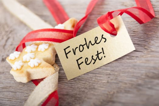 a golden label with the german words Frohes Fest which means merry christmas as background