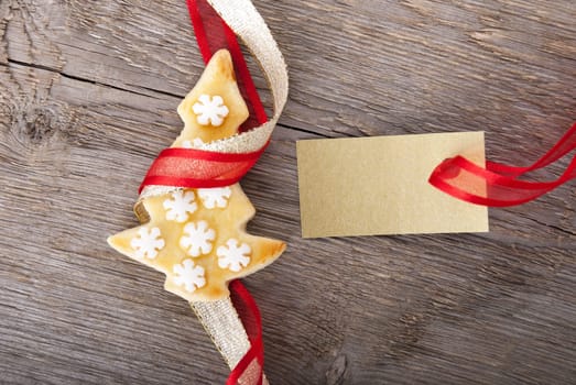 a golden tag with copy space and a christmas cookie as christmas background