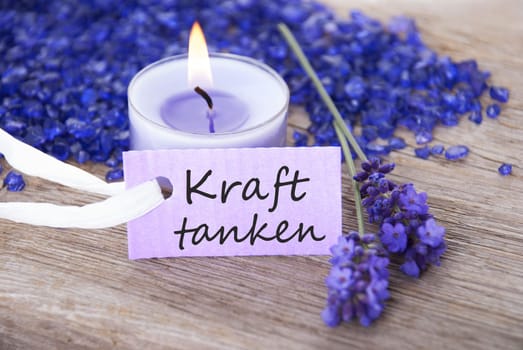 the german words Kraft tanken which means resting on a purple label as wellness background