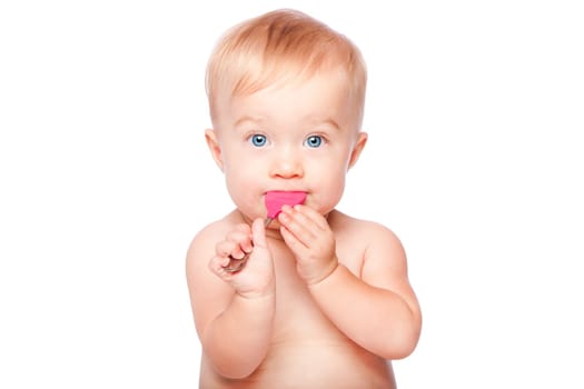 Cute adorable infant baby with food spoon in mouth eating and blue eyes, isolated.