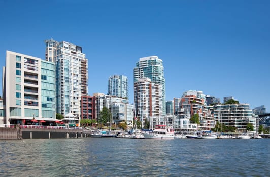 False Creek, a short inlet in the heart of Vancouver, British Columbia, Canada is bordered by tall luxurious condo buildings and their marina. False Creek separates downtown from the rest of the city.