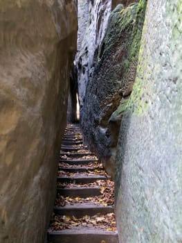 Narrow Parh - Mousehole - in rocks city in Bohemian Paradise..Bohemian Paradise is the Natural Protected Area. It was declared in 1955 was the first nature reserve in the Czech Republic. This part of land is popular thanks to a beautiful and varied countryside. There are a lot of places which should be seen - many natural beauties, castles, chateaus, ruins, museums, and other sights.