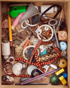 Various objects in old wood drawer - detail