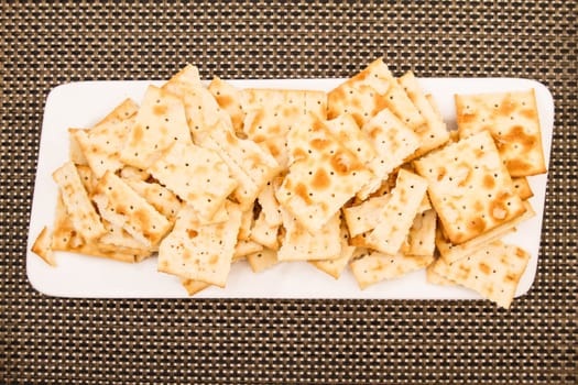 Lots of salted crackers, ones broken.