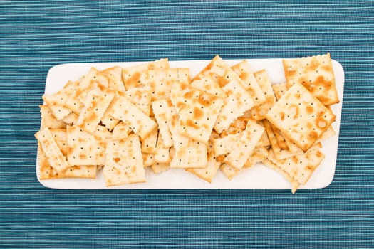 Lots of salted crackers, ones broken.