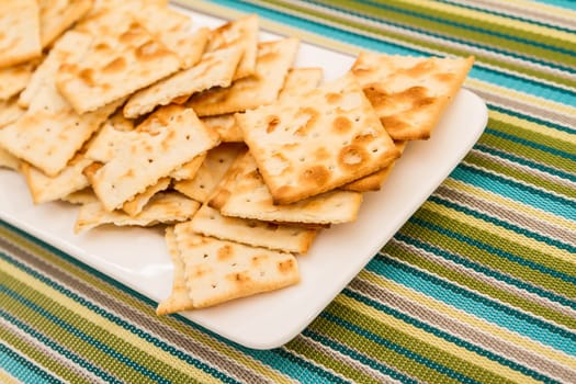 Lots of salted crackers, ones broken.