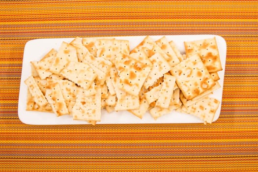 Lots of salted crackers, ones broken.