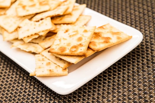 Lots of salted crackers, ones broken.