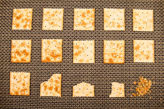 Salted crackers bitten process, background