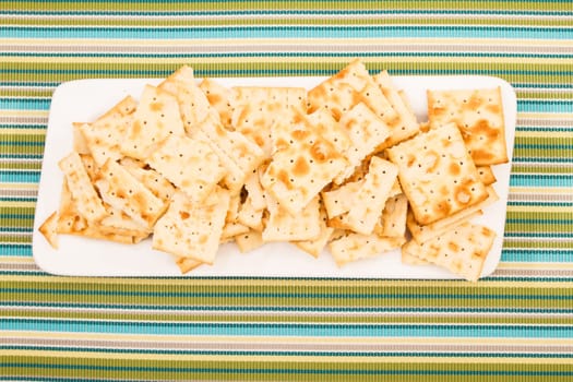 Lots of salted crackers, ones broken.