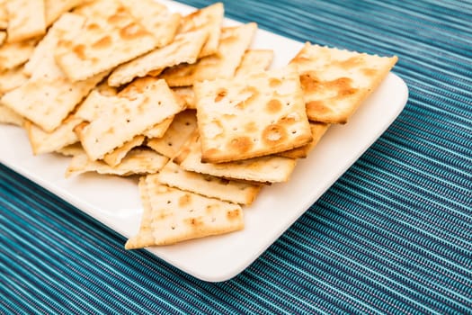 Lots of salted crackers, ones broken.