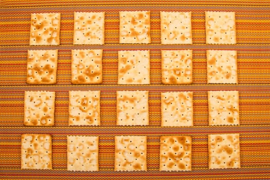 Lots of salted crackers, background.