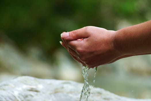 Women's hand at a torrent