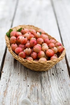 Ripe red gooseberries in a basket close up shoot