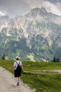 Woman on a trail hiking in the mountains