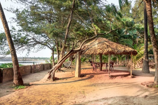Horizontal color capture of a a coconut leaf sun shade shelter in  private walled garden on the coastal area in Bombay India overlooking the Arabian Sea