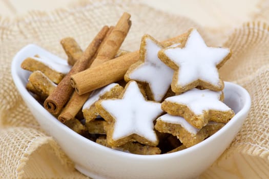 typical christmas cinnamon star cookies and cinnamon sticks