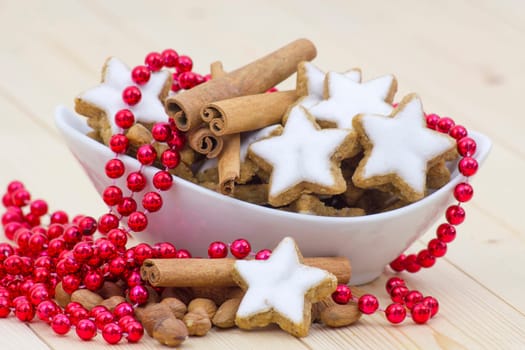 typical christmas cinnamon star cookies, nuts and cinnamon sticks
